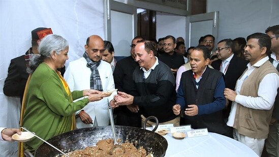 Union finance minister Nirmala Sitharaman distributes halwa to the members of Budget Press during the halwa ceremony ahead of the lock in process of the Budget preparation, in New Delhi on Thursday. (ANI File))
