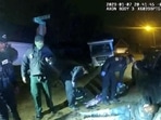 Police officers look at Tyre Nichols, who was pulled over while driving and died three days later, in this screen grab from a video released by Memphis Police.
