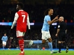 Soccer Football - FA Cup - Fourth Round - Manchester City v Arsenal - Etihad Stadium, Manchester, Britain - January 27, 2023 Manchester City's Nathan Ake celebrates scoring their first goal as Arsenal's Bukayo Saka looks dejected REUTERS/Molly Darlington