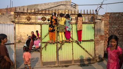 Photographer Graciela Magnoni’s favourite picture of little girls climbing a tall gate to watch a scooter drive by in Kamal Wala village, Ferozepur district. (Courtesy: Graciela Magnoni) Photographer Graciela Magnoni’s favourite picture of little girls climbing a tall gate to watch a scooter drive by in Kamal Wala village, Ferozepur district. (Courtesy: Graciela Magnoni)