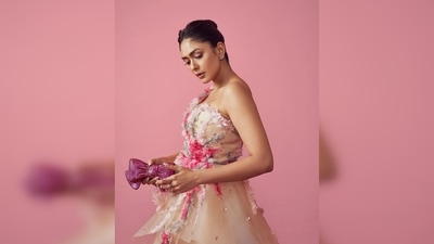 Mrunal Thakur's gown features ruffle detailing, a single shoulder strap and floral work all over the outfit.&nbsp; (Instagram/@mrunalthakur)