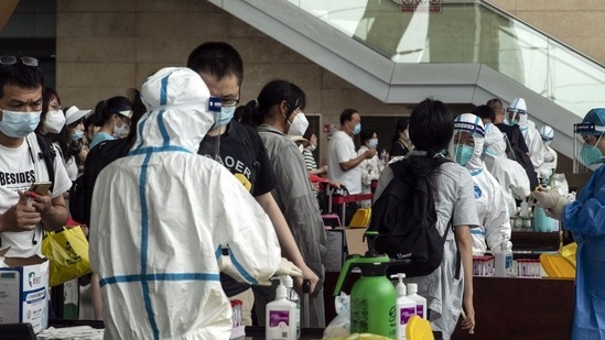 Arriving travelers queue for Covid-19 tests at Changshui International Airport in Kunming, China, on Monday, Aug. 8, 2022. China has become isolated as the rest of the world lives with the virus, and frequent lockdowns, restrictions and mass testing efforts are disrupting the economy, despite moves to mitigate the blow in recent months. Photographer: Qilai Shen/Bloomberg (Bloomberg)
