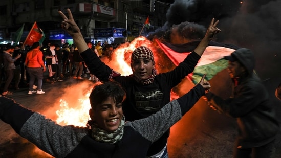 Palestinians celebrate in Gaza City on January 27, 2023, following a shooting attack by a Palestinian gunman outside an east Jerusalem synagogue.(AFP)
