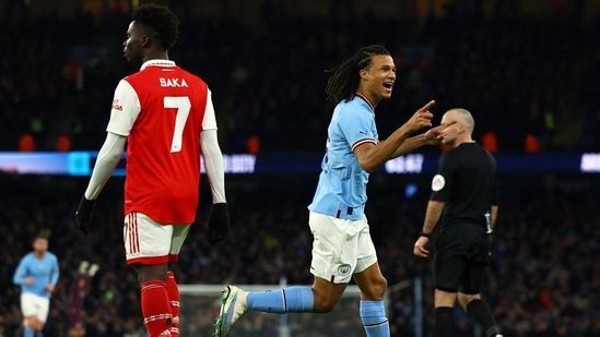 Soccer Football - FA Cup - Fourth Round - Manchester City v Arsenal - Etihad Stadium, Manchester, Britain - January 27, 2023 Manchester City's Nathan Ake celebrates scoring their first goal as Arsenal's Bukayo Saka looks dejected REUTERS/Molly Darlington(REUTERS)