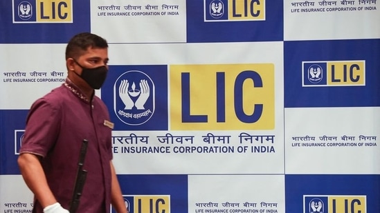 A man walks past a hoarding of Life Insurance Corporation of India (LIC) in Mumbai.(REUTERS file)