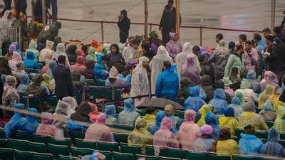 People wearing raincoats sit to watch the Beating Retreat ceremony. (PTI) People wearing raincoats sit to watch the Beating Retreat ceremony. (PTI)
