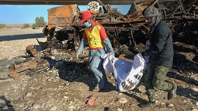Rescue workers collect remains from the burnt wreckage of a bus accident in Bela, an area of Lasbela district of Balochistan province, Pakistan, Sunday, Jan. 29, 2023. The passenger bus fell into a ravine and caught fire killing dozens people in southern Pakistan on Sunday, a government official said. (AP Photo) (AP) Rescue workers collect remains from the burnt wreckage of a bus accident in Bela, an area of Lasbela district of Balochistan province, Pakistan, Sunday, Jan. 29, 2023. The passenger bus fell into a ravine and caught fire killing dozens people in southern Pakistan on Sunday, a government official said. (AP Photo) (AP)