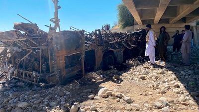 Images from the crash site showed what was left of the charred bus lying near the bridge. The recovered remains of some of the dead are lined up in rows nearby. (AP) Images from the crash site showed what was left of the charred bus lying near the bridge. The recovered remains of some of the dead are lined up in rows nearby. (AP)