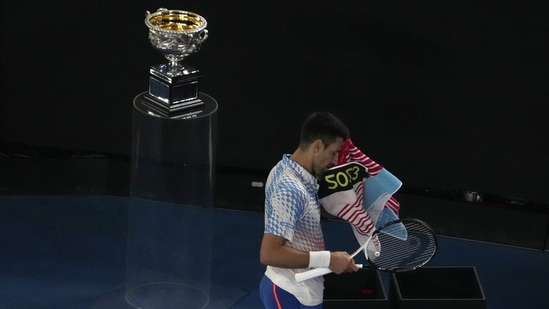 Novak Djokovic of Serbia uses a towel to wipe off his face while playing against Stefanos Tsitsipas of Greece during the men's singles final at the Australian Open(AP)
