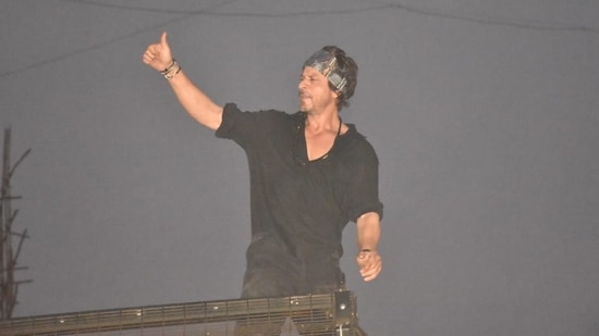 Shah Rukh Khan was spotted waving to his fans outside his home, Mannat on Sunday. He stood on his specially constructed balcony to greet his fans and thank them for their response for Pathaan. (Varinder Chawla)