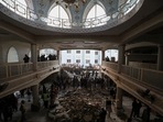 People and rescue workers gather to look for survivors under a collapsed roof, after a suicide blast in a mosque in Peshawar, Pakistan January 30, 2023. 