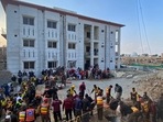 Security officials and rescue workers search bodies at the site of suicide bombing in Peshawar.