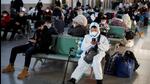 A person wearing a protective suit sits in Beijing Railway Station as passengers wait to board a train to travel for Spring Festival ahead of Chinese Lunar New Year festivities after China lifted its Covid-19 restrictions in Beijing. (REUTERS) A person wearing a protective suit sits in Beijing Railway Station as passengers wait to board a train to travel for Spring Festival ahead of Chinese Lunar New Year festivities after China lifted its Covid-19 restrictions in Beijing. (REUTERS)