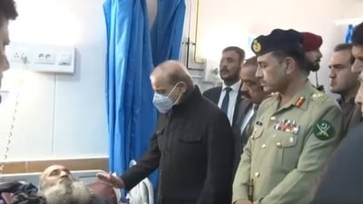 Pakistan prime minister Shehbaz Sharif enquires about the condition of a victim of Peshawar blast at the Lady Reading Hospital. (Twitter/External Publicity Wing, Pakistan)