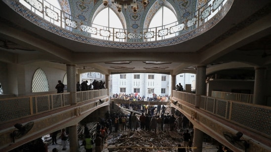 People and rescue workers gather to look for survivors under a collapsed roof, after a suicide blast in a mosque in Peshawar, Pakistan January 30, 2023. (REUTERS)