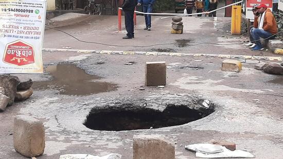 The cave-in at the entrance of Sushant Lok-1 in Gurugram on Monday. (Parveen Kumar/ HT)