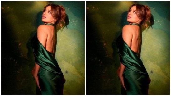 Bhumi looked every bit gorgeous in the green satin gown with wraparound details around her torso, featuring halter neck details and midriff-baring patterns. (Instagram/@bhumipednekar)