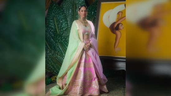 Masaba Gupta wore a barfi pink 'paan-patti' lehenga which she paired with two dupattas - one in lime green wallflower print dupatta with a sequinned border and the other with 'open hearts' embellished on it in rani pink. (Instagram/@masabagupta)