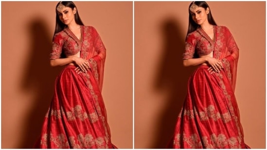 Mouni teamed it with a long flowy red silk skirt with golden embroidery details throughout, and added a red organza dupatta with golden zari details at the border. (Instagram/@imouniroy)