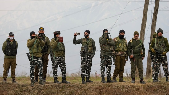 Security personnel stand guard during the Congress' 'Bharat Jodo Yatra', at Awantipora in Pulwama District of South Kashmir, Saturday, Jan. 28, 2023.(PTI)