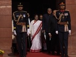 Indian President Droupadi Murmu, center, walks in a procession towards the central hall to address the opening day of the Parliament's budget session, in New Delhi, India, Tuesday, Jan. 31, 2023. (AP Photo/Manish Swarup)