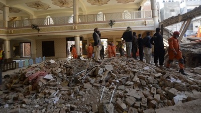 Rescue workers gather as they conduct an operation to clear the rubble and search for bodies at the site of Monday's suicide bombing, in Peshawar, Pakistan, Tuesday. (AP) Rescue workers gather as they conduct an operation to clear the rubble and search for bodies at the site of Monday's suicide bombing, in Peshawar, Pakistan, Tuesday. (AP)