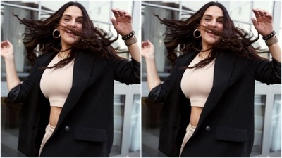 Neha decked up in an ivory white cropped top and teamed it with a pair of cotton trousers with thigh high slits. In the oversized black blazer, she looked just too stunning.&nbsp; (Instagram/@nehadhupia)