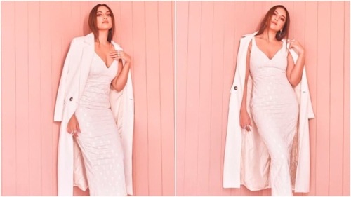 Sonakshi looks stunning in a white, deep neck bodycon dress which she paired with a white overcoat. (Instagram/@aslisona) Sonakshi looks stunning in a white, deep neck bodycon dress which she paired with a white overcoat. (Instagram/@aslisona)