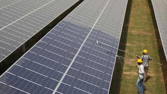 Workers clean photovoltaic panels inside a solar power plant in Gujarat, India. US senator Bob Menendez has introduced a legislation for cooperation between the United States and India related to clean climate technologies and energy transmission. (REUTERS)