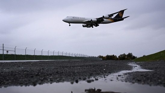 A United Parcel Service (UPS) Boeing 747 cargo aircraft is reflected in a puddle as it lands in the rain at the Ted Stevens International Airport (ANC) in Anchorage, Alaska. (AFP)