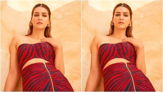 Kriti styled the ensemble with black strappy stilettos, gold statement rings, and half-hoop patterned earrings. In the end, Kriti chose smoky eye shadow, feathered brows, pink lips, mascara on the lashes, and a centre-parted half-tied bun.&nbsp;(Instagram)