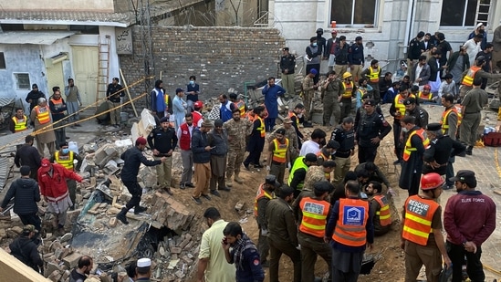 Security officials and rescue workers search bodies at the site of suicide bombing, in Peshawar, Pakistan.(AP) Security officials and rescue workers search bodies at the site of suicide bombing, in Peshawar, Pakistan.(AP)
