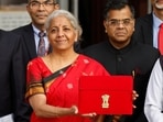 Finance Minister Nirmala Sitharaman holds up a folder with the Government of India?s logo as she leaves her office to present budget 2023 in the parliament, 