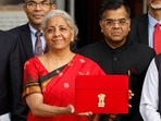 Finance Minister Nirmala Sitharaman holds up a folder with the Government of India's logo as she leaves her office to present the Union budget in the parliament.