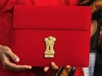 Finance minister Nirmala Sitharaman holds up a folder with the government of India's logo as she leaves her office to present the budget 2023 in Parliament, 