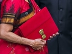 Union Finance Minister Nirmala carrying a folder-case poses for photographs outside the Finance Ministry at North Block, in New Delhi, Wednesday.(PTI) Union Finance Minister Nirmala carrying a folder-case poses for photographs outside the Finance Ministry at North Block, in New Delhi, Wednesday.(PTI)