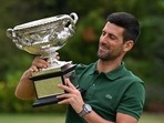 Serbia's Novak Djokovic celebrates with the Norman Brookes Challenge Cup trophy following his victory against Greece's Stefanos Tsitsipas in the men's singles final match on day fourteen of the Australian Open tennis tournament in Melbourne on January 29, 2023. (Photo by Saeed KHAN / AFP) / -- IMAGE RESTRICTED TO EDITORIAL USE - STRICTLY NO COMMERCIAL USE --(AFP) Serbia's Novak Djokovic celebrates with the Norman Brookes Challenge Cup trophy following his victory against Greece's Stefanos Tsitsipas in the men's singles final match on day fourteen of the Australian Open tennis tournament in Melbourne on January 29, 2023. (Photo by Saeed KHAN / AFP) / -- IMAGE RESTRICTED TO EDITORIAL USE - STRICTLY NO COMMERCIAL USE --(AFP)