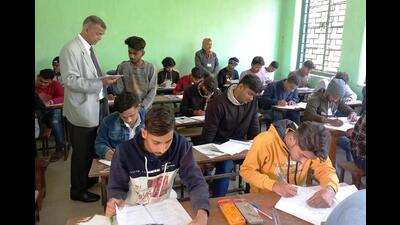 BSEB chairman Anand Kishor inspects an examinee at an examination centre in Patna on Wednesday. (Santosh Kumar/HT Photo)