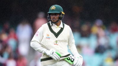 Australia�s Usman Khawaja puts his bat under his jumper as he walks off the ground due to a rain delay during day two of the third cricket Test match between Australia and South Africa at the Sydney Cricket Ground (SCG) in Sydney on January 5, 2023. (Photo by DAVID GRAY / AFP) / - IMAGE RESTRICTED TO EDITORIAL USE - STRICTLY NO COMMERCIAL USE- (AFP) Australia�s Usman Khawaja puts his bat under his jumper as he walks off the ground due to a rain delay during day two of the third cricket Test match between Australia and South Africa at the Sydney Cricket Ground (SCG) in Sydney on January 5, 2023. (Photo by DAVID GRAY / AFP) / - IMAGE RESTRICTED TO EDITORIAL USE - STRICTLY NO COMMERCIAL USE- (AFP)