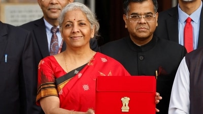 Finance Minister Nirmala Sitharaman holds up a folder with the Government of India?s logo as she leaves her office to present budget 2023 in the parliament, (REUTERS)