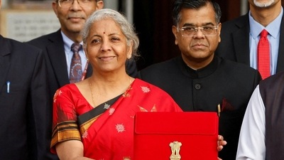 Finance Minister Nirmala Sitharaman holds up a folder with the Government of India's logo as she leaves her office to present the Union budget in the parliament. (REUTERS)