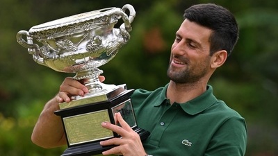Serbia's Novak Djokovic celebrates with the Norman Brookes Challenge Cup trophy following his victory against Greece's Stefanos Tsitsipas in the men's singles final match on day fourteen of the Australian Open tennis tournament in Melbourne on January 29, 2023. (Photo by Saeed KHAN / AFP) / -- IMAGE RESTRICTED TO EDITORIAL USE - STRICTLY NO COMMERCIAL USE -- (AFP) Serbia's Novak Djokovic celebrates with the Norman Brookes Challenge Cup trophy following his victory against Greece's Stefanos Tsitsipas in the men's singles final match on day fourteen of the Australian Open tennis tournament in Melbourne on January 29, 2023. (Photo by Saeed KHAN / AFP) / -- IMAGE RESTRICTED TO EDITORIAL USE - STRICTLY NO COMMERCIAL USE -- (AFP)
