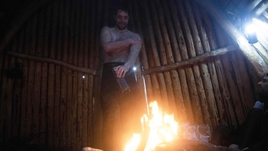 Arthur Guerin-Boeri warms up in an old traditional artic hut, preparing for his dive with the Orcas, in the Spildra Island northern Arctic Circle. On most days, all he waits for to step into the frigid waters is a glimpse of a fin emerging from the gloomy depths off the island of Spildra. (Olivier Morin / AFP)