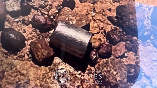 A radioactive capsule, which had fallen off a truck, after it was found along a desert highway south of Newman, Western Australia.(AFP) A radioactive capsule, which had fallen off a truck, after it was found along a desert highway south of Newman, Western Australia.(AFP)