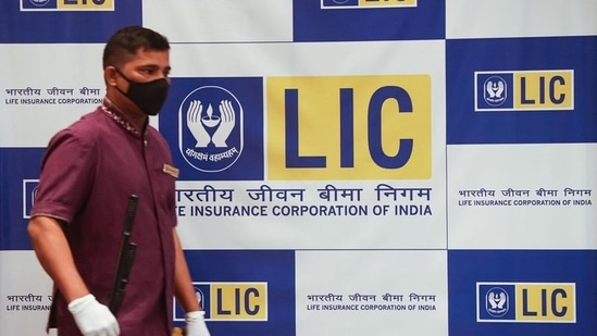 A man walks past a hoarding of Life Insurance Corporation of India (LIC) in Mumbai.(REUTERS file)