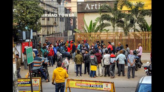 Residents of 'Ashirwad Tower' gather outside in Dhanbad district on Wednesday. (PTI)