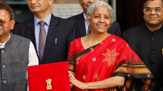 Finance Minister Nirmala Sitharaman holds up a folder with the Government of India's logo as she leaves her office to present the Union budget in the parliament, in New Delhi, India.(Reuters)