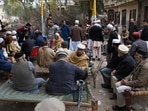 People gather outside the house of a victim, who was killed in mosque suicide blast inside a police headquarters, in Peshawar on February 1. (AFP)