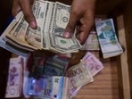 A dealer counts US dollars at a money exchange market in Karachi. (File) A dealer counts US dollars at a money exchange market in Karachi. (File)