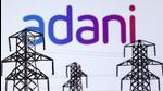 Electric power transmission pylon miniatures and Adani Green Energy logo are seen in this illustration (REUTERS File) Electric power transmission pylon miniatures and Adani Green Energy logo are seen in this illustration (REUTERS File)
